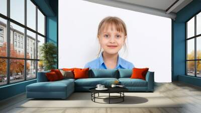 Portrait of a charming little girl smiling at camera, isolated on white background Wall mural