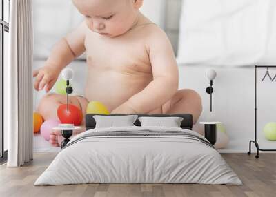 Portrait of a cute baby dressed in Easter bunny ears with a basket full of eggs Wall mural