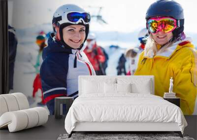 Portrait of two pretty skier woman Wall mural