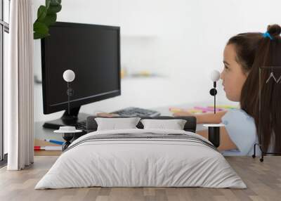 Pretty stylish schoolgirl studying homework math during her online lesson at home, social distance during quarantine, self-isolation, online education concept, home schooler Wall mural