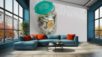 Saving money coin in jar. Symbol of investing, keeping money concept. Collecting cash banknotes in glass tin as moneybox. American dollars close-up with increasing columns of gold coins on table Wall mural