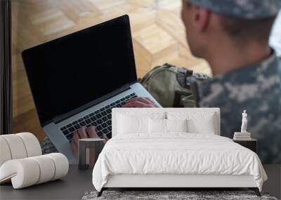 Soldier holding laptop. Military education concept Wall mural