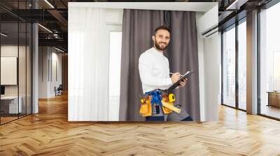 Technician repairing air conditioner on the wall Wall mural