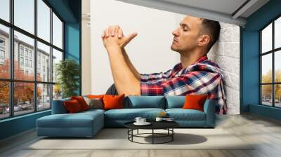 Thoughtful young man in the living room Wall mural