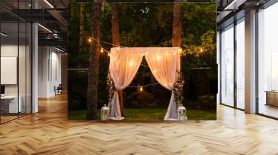 wedding twilight ceremony decoration made of hanging on a tree golden lanterns and lamps and standin Wall mural