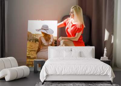 woman holds canvas at home Wall mural