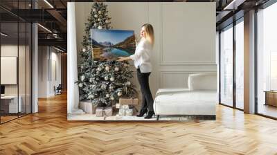 woman with photo canvas at christmas Wall mural