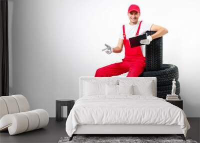 Young mechanic in uniform with a clipboard on white background Wall mural