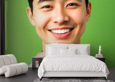 Portrait young man holding glass of milk happy smiling Wall mural