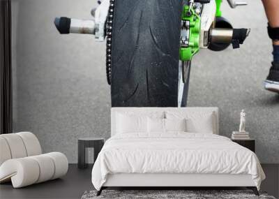 Moto rider on his motorbike, stunt riding. Wheel of a sports motorcycle closeup, rear view Wall mural