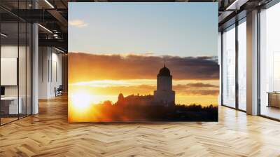 Saint Olav tower, medieval Swedish fortress castle on the sunset background in Vyborg, Russia. Rays of the autumn sunset sun, sun glare Wall mural