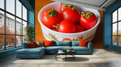 Freshly picked bright red home grown tomatoes, variety Mountain Magic, in a small bowl Wall mural