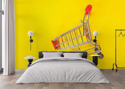 red shopping cart top view on yellow background. Wall mural