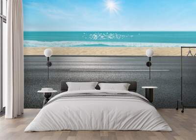 Side view of Asphalt straight street roadway of lanes with lines and seascape view in background. Wall mural