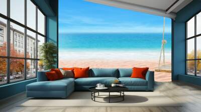 Summer Vacation and Holiday Trip Concept : Wooden swing and coconut palm leaves with beautiful tropical seascape view and sunlight in background. Wall mural