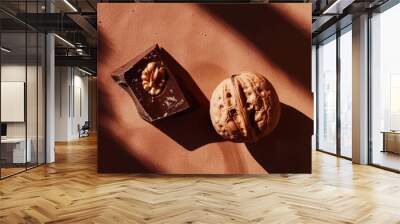 Peeled walnuts and delicious piece of dark chocolate on aesthetic dark brown background. Chocolate ad. Generative AI Wall mural