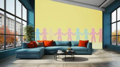 Teamwork and helping concept with paper chain cutout people holding hands on pastel yellow background. Generative AI Wall mural