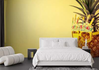 yellow fancy glasses on fresh pineapple, copy space on left, summer birthday concept, retro color tone Wall mural