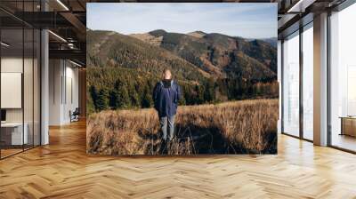 Going the distance. Shot of a young man enjoying a hike through the mountains. a handsome man with an athletic build is traveling in the mountains. landscape 
 Wall mural