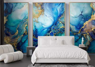 A set of three abstract alcohol ink wall art panels in vibrant shades of blue and gold. The rich colors create an impression of fluidity and luxury in modern decor. Wall mural