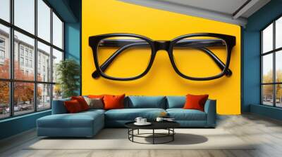 Stylish modern black glasses with a thin frame on bright yellow background. Wall mural