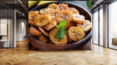 Crispy fried sliced banana with sugar,sweet banana chips in wooden bowl Wall mural