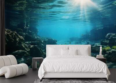 Deep ocean full of life. Underwater coral reef with fish and rays of sun through water surface Wall mural