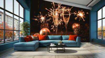 Two glasses of champagne in Bengal lights with christmas decorations Wall mural