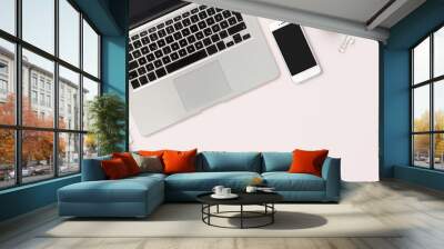 modern header / hero image or banner with laptop computer, smartphone, air plant, open notebook and feminine accessories on a bright blush background, home office scene, flat lay / top view Wall mural