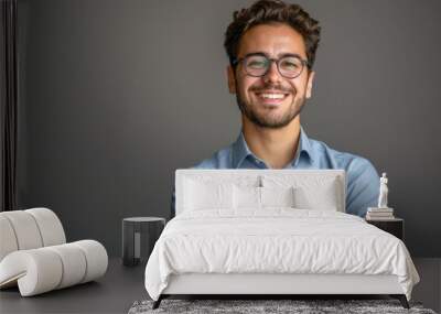 Confident young businessman in blue shirt and glasses. Wall mural