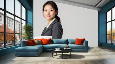 Happy Asian businesswoman holding laptop  isolated on white background. Wall mural