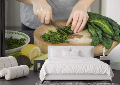 Closeup of woman's hands cooking vegetables salad in the kitchen Wall mural