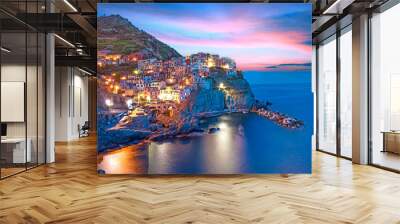 Magical beautiful landscape with bright colored houses on the rock on the sea coast of Manarola in Cinque Terre, Liguria, Italy, Europe in the evening Wall mural