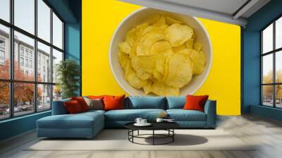 plate with chips on a yellow background top view Wall mural