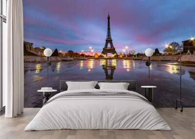 Sunrise on the Eiffel tower reflection on the Trocadero fountain water in Paris, one of the most visited building by the tourists Wall mural