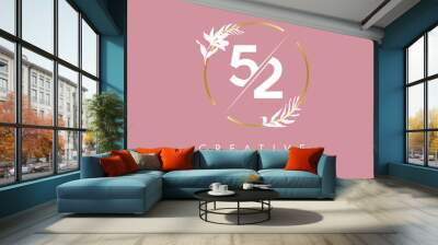 Numbers 52 5 2 logo design with golden circle and white leaves on branches around. Vector Illustration with numbers 5 and 2. Wall mural