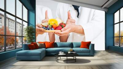 Banner selective focus on hands of chef holding, showing thumb up, plate of meal for breakfast,cooking in kitchen together, smiling with happiness and confidence. Food Concept. Wall mural