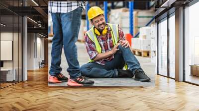 Selective focus, Portrait Male Engineer or worker wearing safety hard hat, getting dangerous risk accident, njured or pain on knee while working in factory. Industry Concept. Wall mural