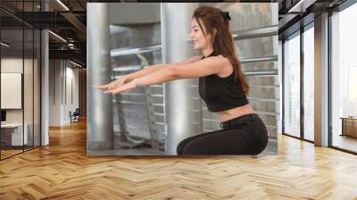 Sportive woman doing exercise outdoor Wall mural