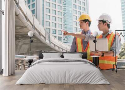 Two engineers discuss about the projects and construction site Wall mural