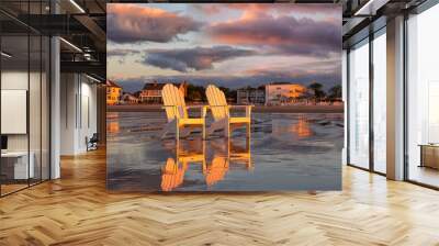 Two wooden traditional armchairs on a sandy beach at sunrise overlooking the coastline. Atlantic Ocean. USA. Maine. Old Orchard Beach. Wall mural