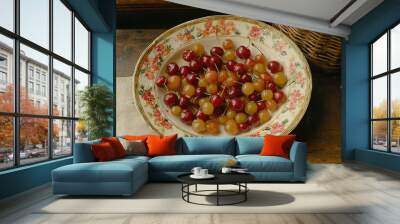   A bowl of cherries on a table, alongside a basket of cherries on the same table Wall mural