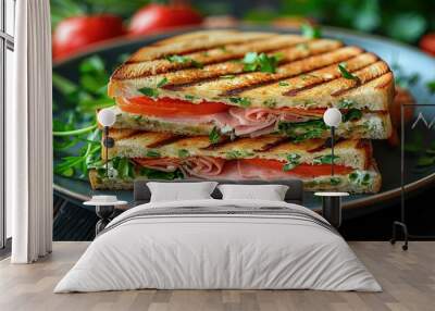   A close-up of a grilled sandwich on a plate with juicy red tomatoes and fresh green garnish on the side Wall mural