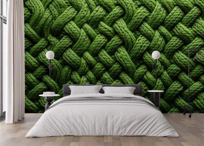  a close up view of a green knitted fabric with a braiding pattern on the side of the fabric. Wall mural