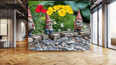   A cluster of miniature goblin figurines perched upon a railroad track, surrounded by flora and a verdant landscape Wall mural