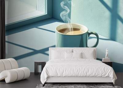   A cup of coffee sits on a table near a window, casting a shadow of steam rising from it Wall mural