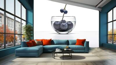  a glass bowl filled with blueberries and a single stem of a cherry on top of the bowl, on a white surface, with a white background.  generative ai Wall mural