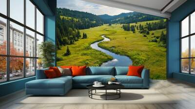   A lush green forest filled with tall pine trees borders a river running through a verdant field Wall mural