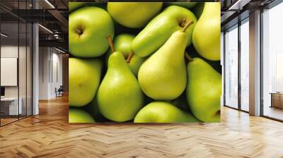  a pile of green pears and pears with one pear cut in half and one pear in the middle. Wall mural