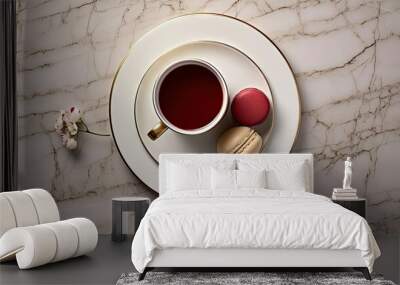  a white plate topped with a cup of tea and two macaroons on top of a white marble table. Wall mural